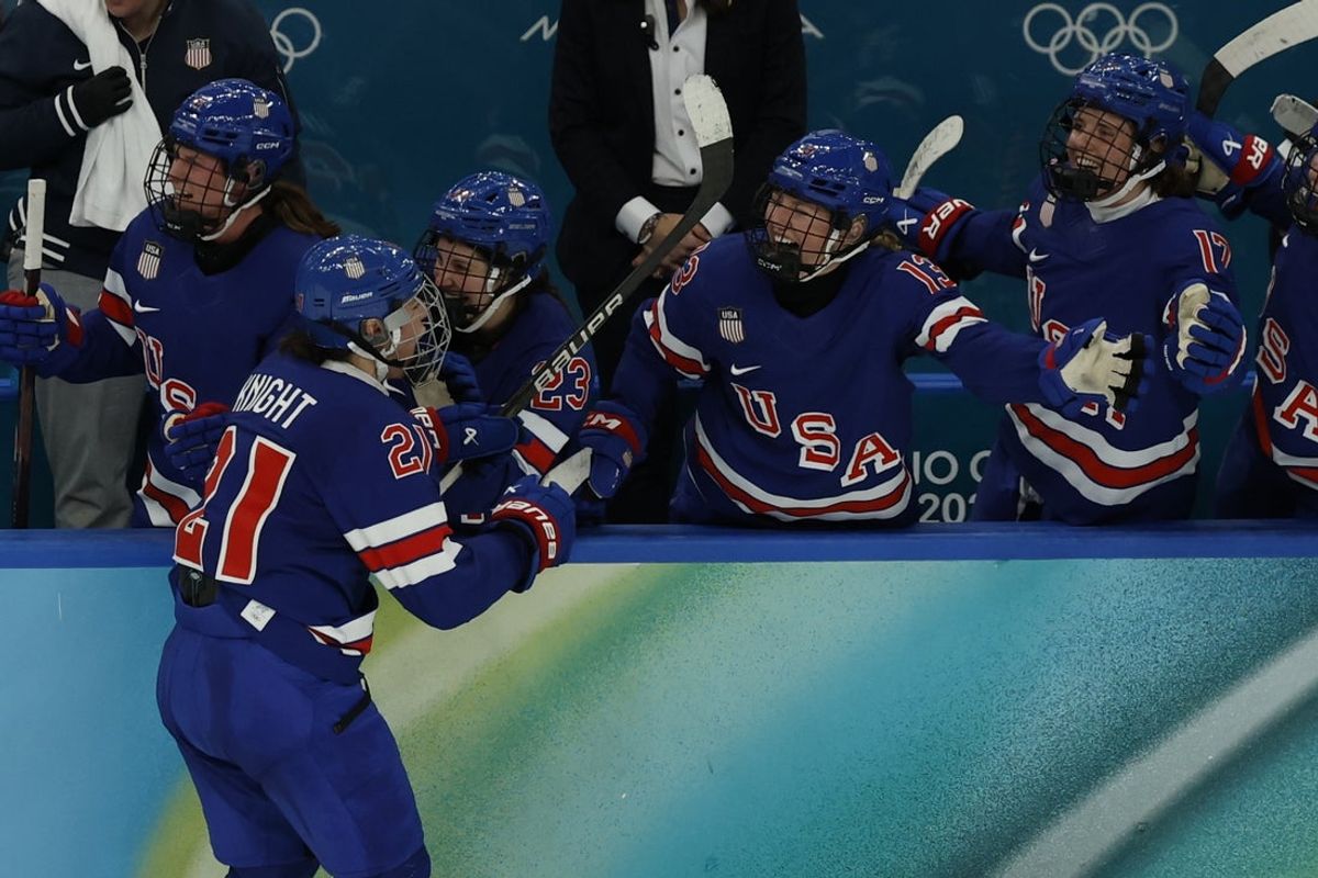 Feb 19, 2026; Milan, Italy; Hilary Knight (21) of the United States high fives the bench after scoring a goal against Canada in the women's ice hockey gold medal game during the Milano Cortina 2026 Olympic Winter Games at Milano Santagiulia Ice Hockey Arena. Mandatory Credit: Geoff Burke-Imagn Images