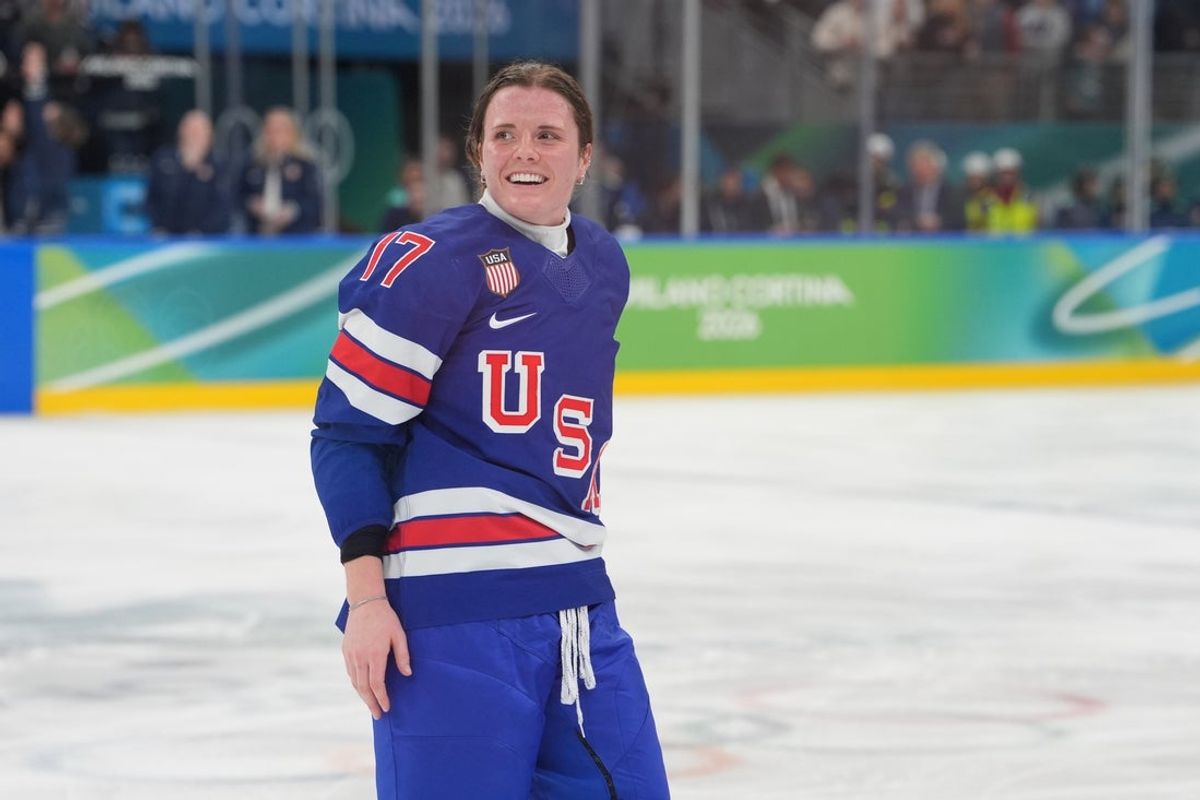 Feb 19, 2026; Milan, Italy; Britta Curl (17) of the United States celebrates winning the gold medal following overtime of the women's ice hockey gold medal game against Canada during the Milano Cortina 2026 Olympic Winter Games at Milano Santagiulia Ice Hockey Arena. Mandatory Credit: Amber Searls-Imagn Images