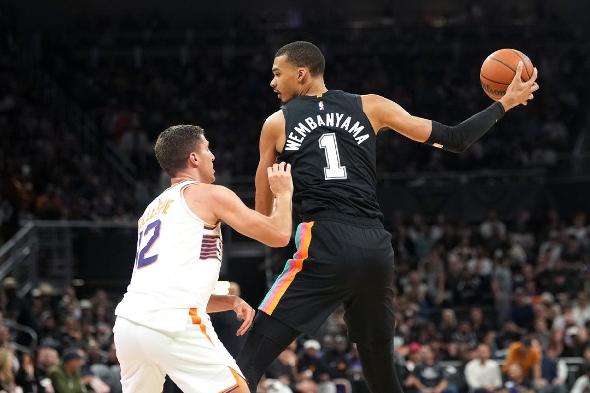 Feb 19, 2026; Austin, Texas, USA; San Antonio Spurs forward Victor Wembanyama (1) prepares to drives to the basket against Phoenix Suns guard Collin Gillespie (12) during the first half against the Phoenix Suns at Moody Center. Mandatory Credit: Scott Wachter-Imagn Images