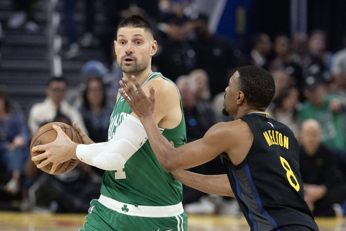 Feb 19, 2026; San Francisco, California, USA; Boston Celtics center Nikola Vucevic (4) looks to pass around Golden State Warriors guard De'Anthony Melton (8) during the first quarter at Chase Center. Mandatory Credit: D. Ross Cameron-Imagn Images