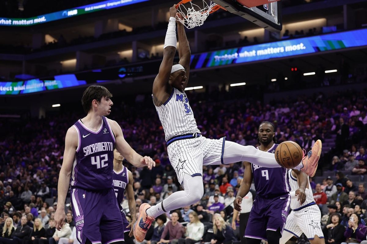Feb 19, 2026; Sacramento, California, USA; Orlando Magic forward/guard Desmond Bane (3) dunks the ball between Sacramento Kings center Maxime Raynaud (42) and forward Precious Achiuwa (9) during the second quarter at Golden 1 Center. Mandatory Credit: Kelley L Cox-Imagn Images