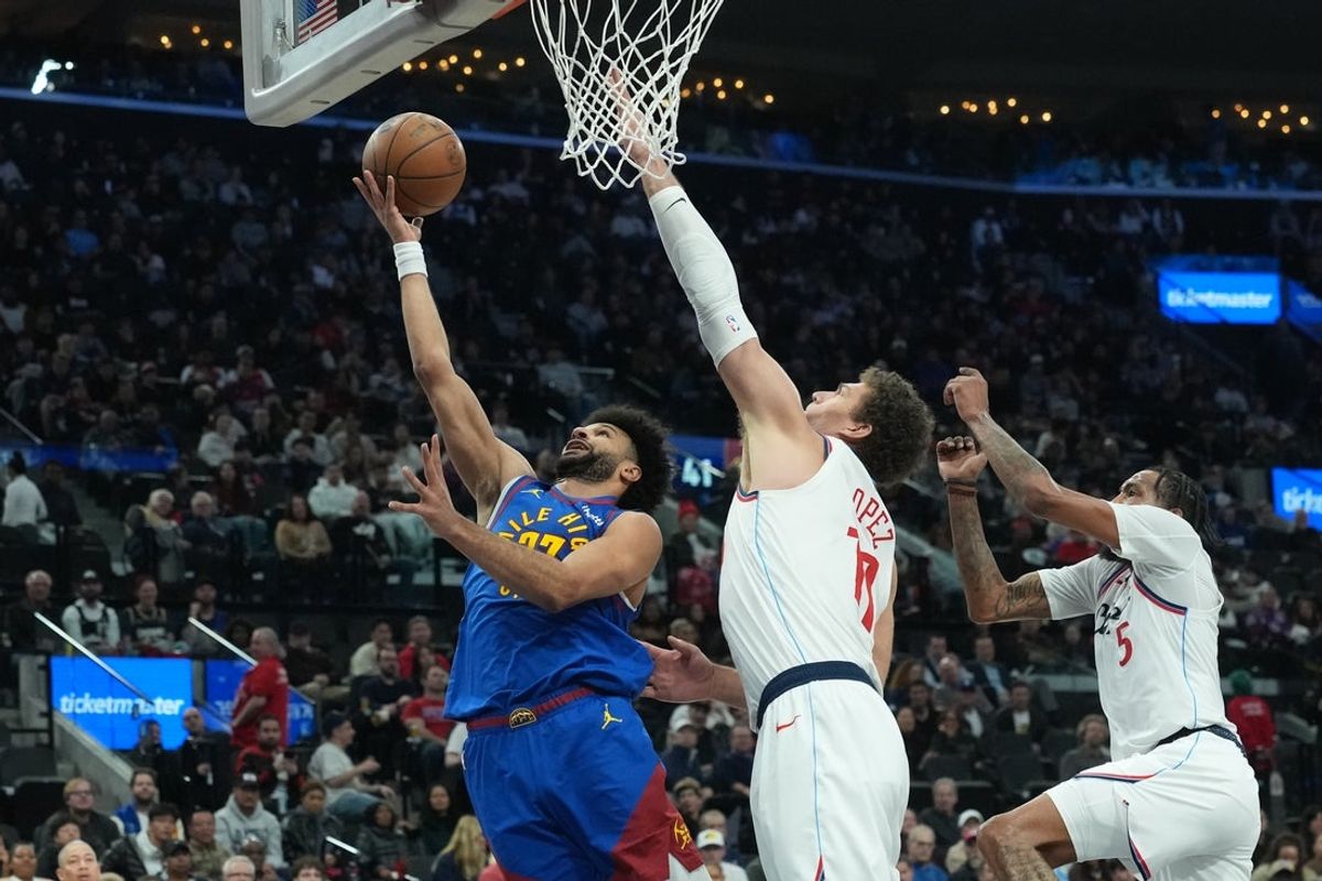 Feb 19, 2026; Inglewood, California, USA; Denver Nuggets guard Jamal Murray (27) shoots the ball against LA Clippers center Brook Lopez (11) and forward Derrick Jones Jr. (5) in the first half at Intuit Dome. Mandatory Credit: Kirby Lee-Imagn Images