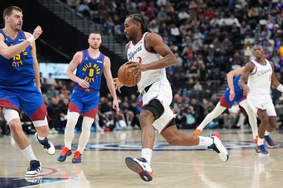 Feb 19, 2026; Inglewood, California, USA; LA Clippers forward Kawhi Leonard (2) dribbles the ball against Denver Nuggets center Nikola Jokic (15) in the second half at Intuit Dome. Mandatory Credit: Kirby Lee-Imagn Images