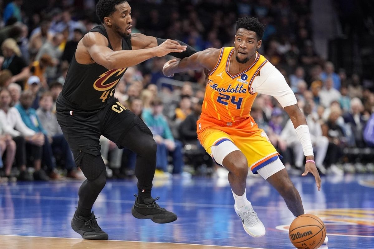 Feb 20, 2026; Charlotte, North Carolina, USA; Charlotte Hornets forward Brandon Miller (24) drives against Cleveland Cavaliers guard Donovan Mitchell (45) during the first quarter at the Spectrum Center. Mandatory Credit: Jim Dedmon-Imagn Images