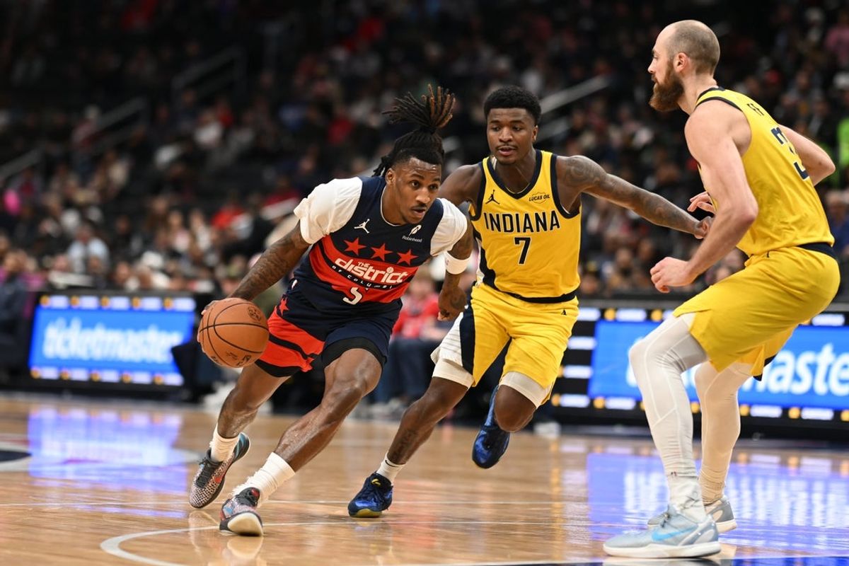 Feb 20, 2026; Washington, District of Columbia, USA; Washington Wizards guard Jamir Watkins (5) drives against ndiana Pacers guard Kam Jones (7) and center Jay Huff (32) during the second quarter at Capital One Arena. Mandatory Credit: Rafael Suanes-Imagn Images