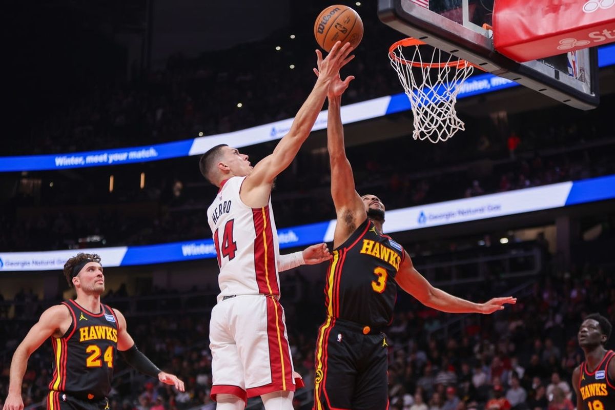 Feb 20, 2026; Atlanta, Georgia, USA; Miami Heat guard Tyler Herro (14) shoots over Atlanta Hawks guard CJ McCollum (3) in the second quarter at State Farm Arena. Mandatory Credit: Brett Davis-Imagn Images
