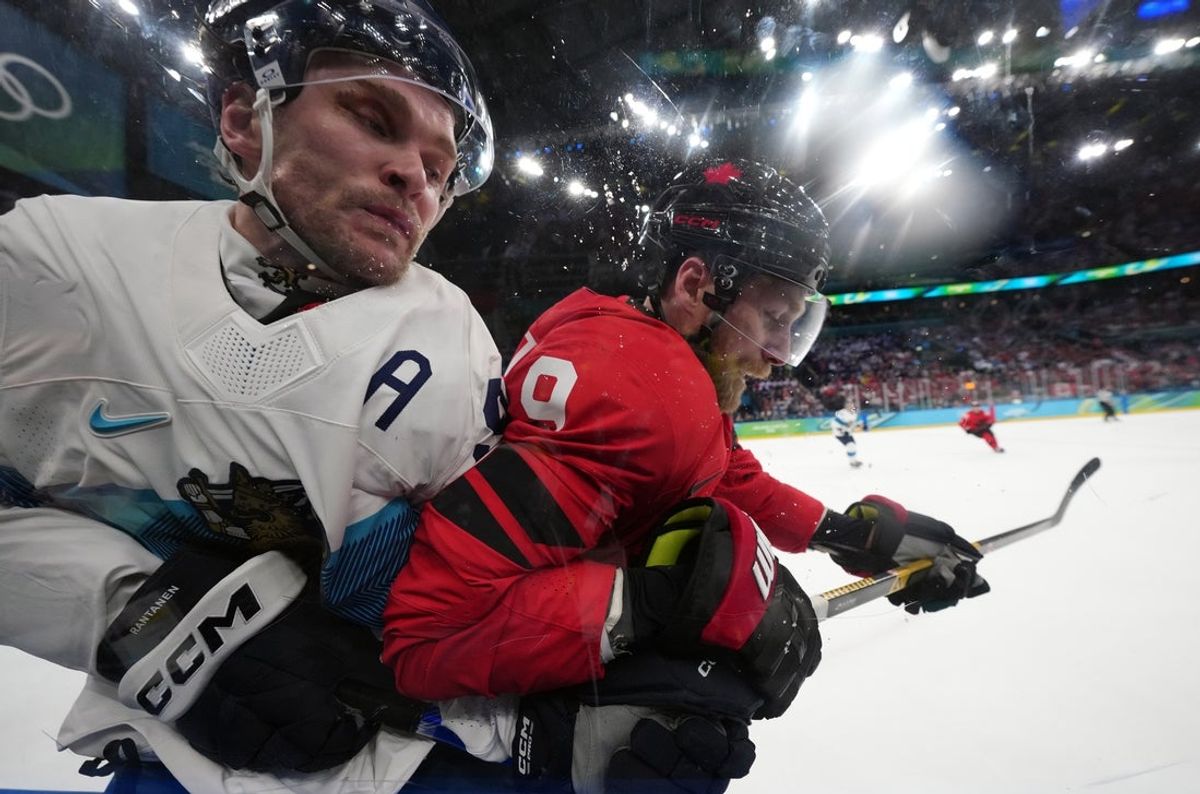 Feb 20, 2026; Milan, Italy; Sam Bennett (9) of Canada checks Mikko Rantanen (96) of Finland into the boards during the second period in a men's ice hockey semifinal during the Milano Cortina 2026 Olympic Winter Games at Milano Santagiulia Ice Hockey Arena. Mandatory Credit: James Lang-Imagn Images