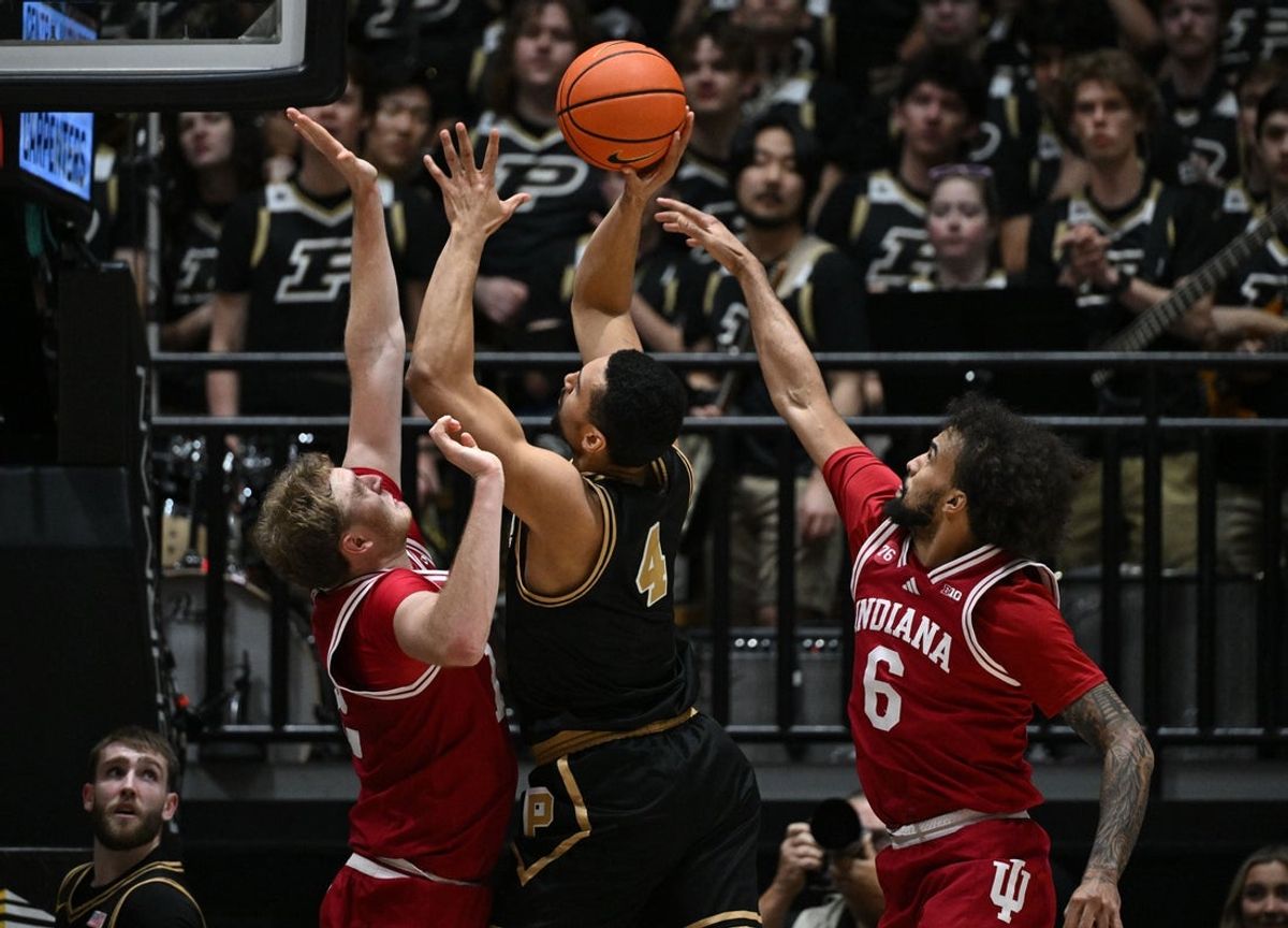 Feb 20, 2026; West Lafayette, Indiana, USA; Purdue Boilermakers forward Trey Kaufman-Renn (4) shoots between Indiana Hoosiers forward Tucker Devries (12) and guard Tayton Conerway (6) during the first half at Mackey Arena. Mandatory Credit: Marc Lebryk-Imagn Images