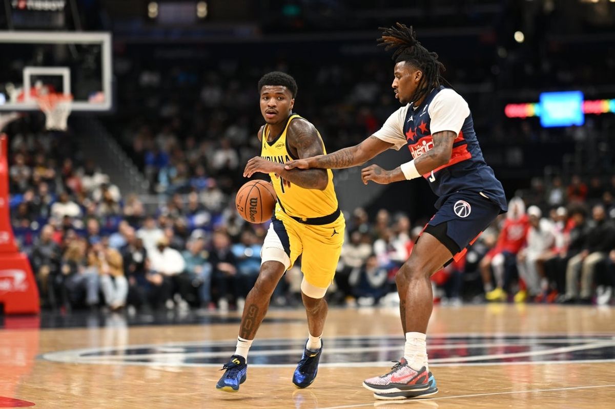 Feb 20, 2026; Washington, District of Columbia, USA; Indiana Pacers guard Kam Jones (7) dribbles past Washington Wizards guard Jamir Watkins (5) during the fourth quarter at Capital One Arena. Mandatory Credit: Rafael Suanes-Imagn Images