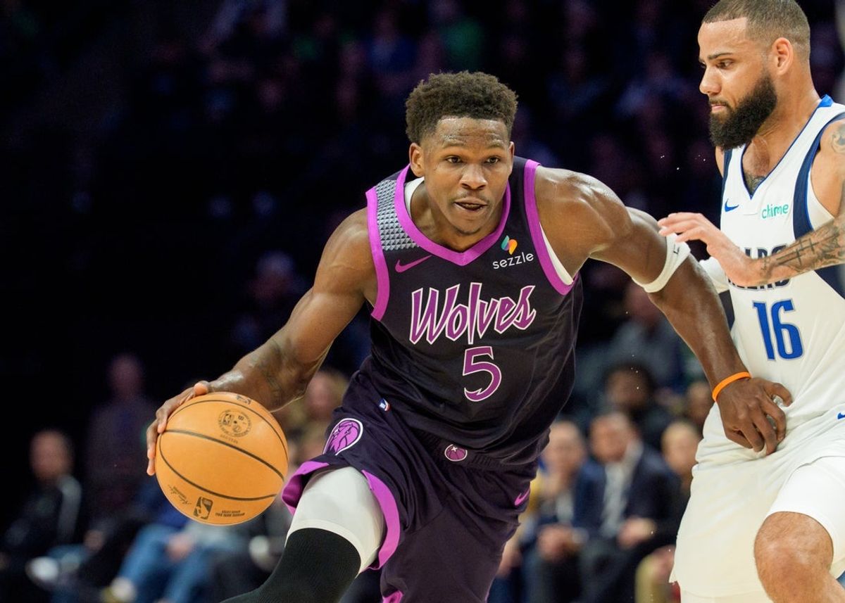 Feb 20, 2026; Minneapolis, Minnesota, USA; Minnesota Timberwolves guard Anthony Edwards (5) dribbles by Dallas Mavericks forward Caleb Martin (16) in the third quarter at Target Center. Mandatory Credit: Matt Blewett-Imagn Images