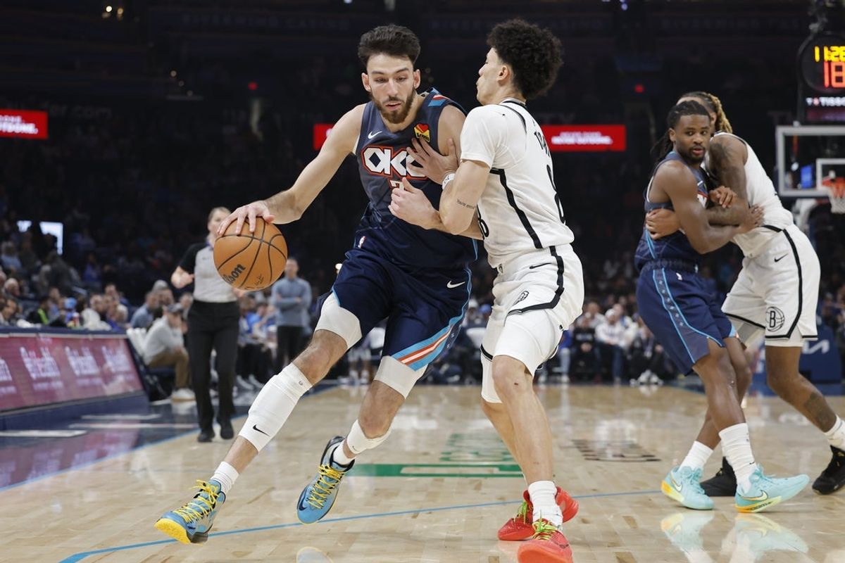 Feb 20, 2026; Oklahoma City, Oklahoma, USA; Oklahoma City Thunder center/forward Chet Holmgren (7) drives down the court against Brooklyn Nets guard Nolan Traore (88) during the second half at Paycom Center. Mandatory Credit: Alonzo Adams-Imagn Images