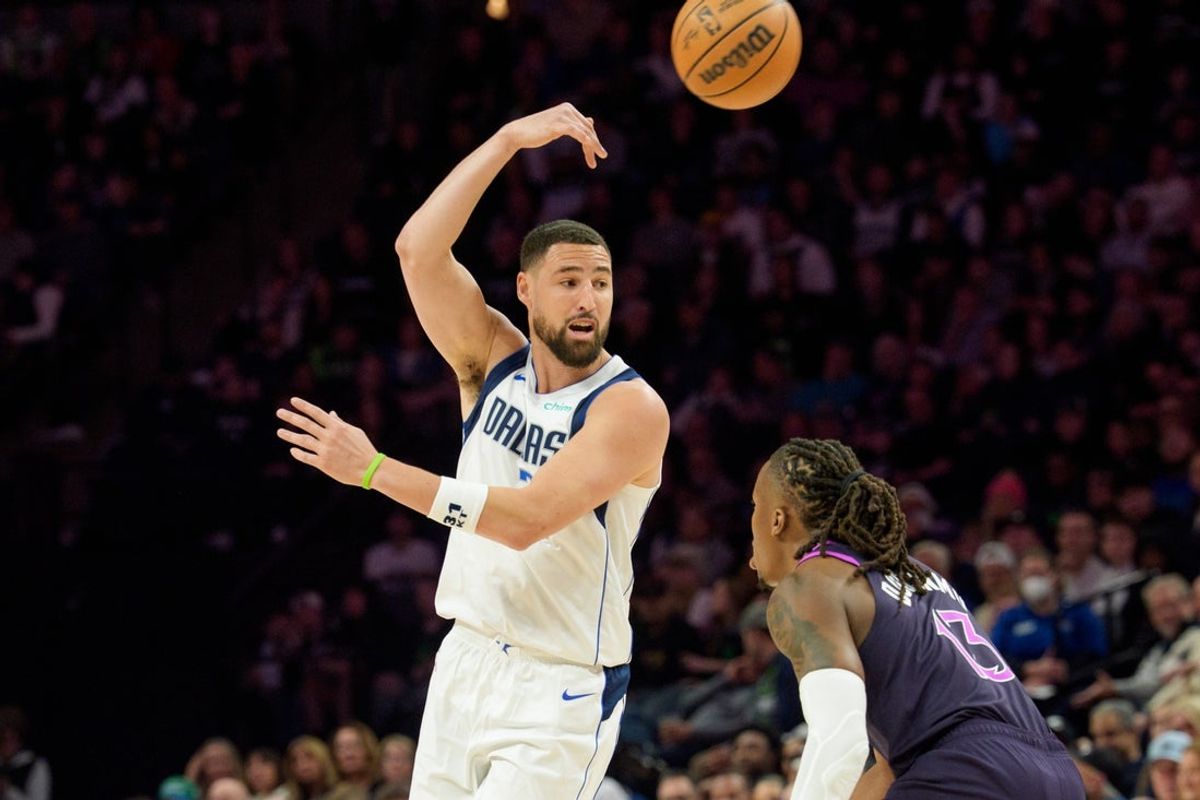 Feb 20, 2026; Minneapolis, Minnesota, USA; Dallas Mavericks guard Klay Thompson (31) passes against Minnesota Timberwolves guard Ayo Dosunmu (13) in the second quarter at Target Center. Mandatory Credit: Matt Blewett-Imagn Images