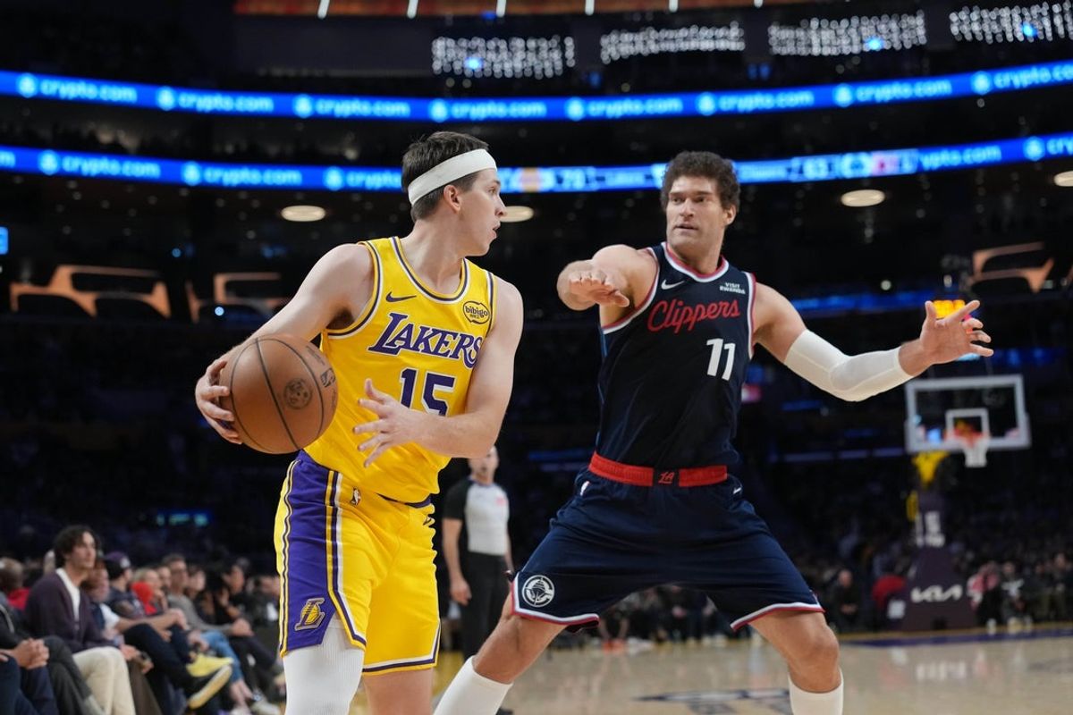 Feb 20, 2026; Los Angeles, California, USA; Los Angeles Lakers guard Austin Reaves (15) dribbles the ball against LA Clippers center Brook Lopez (11) in the first half at Crypto.com Arena. Mandatory Credit: Kirby Lee-Imagn Images