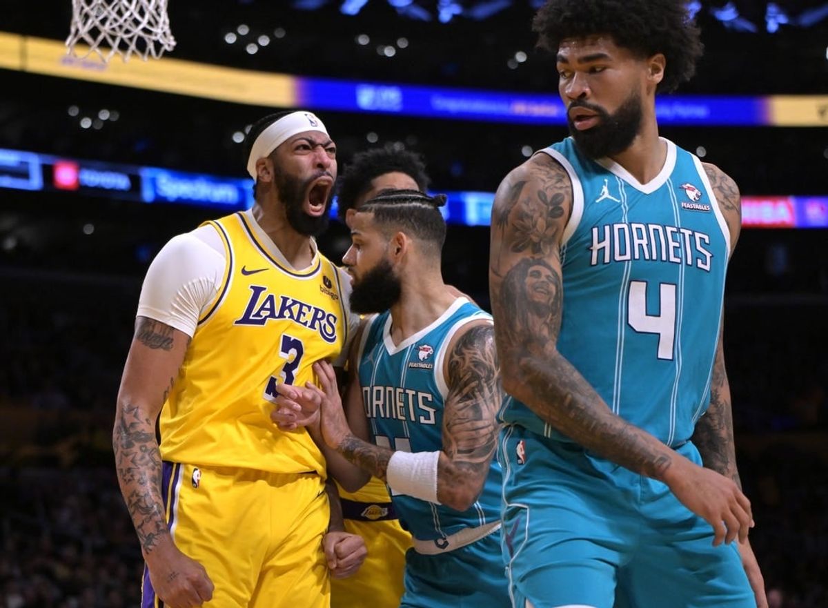 Dec 28, 2023; Los Angeles, California, USA;  Charlotte Hornets forward Cody Martin (11) gets in front of Los Angeles Lakers forward Anthony Davis (3) as he reacts after a dunk over Charlotte Hornets center Nick Richards (4) in the first half at Crypto.com Arena.