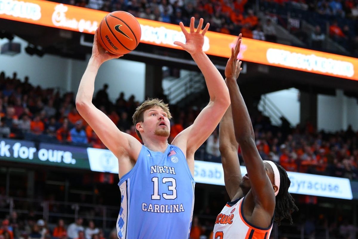 Feb 21, 2026; Syracuse, New York, USA; North Carolina Tar Heels center Henri Veesaar (13) shoots against Syracuse Orange forward William Kyle III (42) during the first half at the JMA Wireless Dome. Mandatory Credit: Rich Barnes-Imagn Images