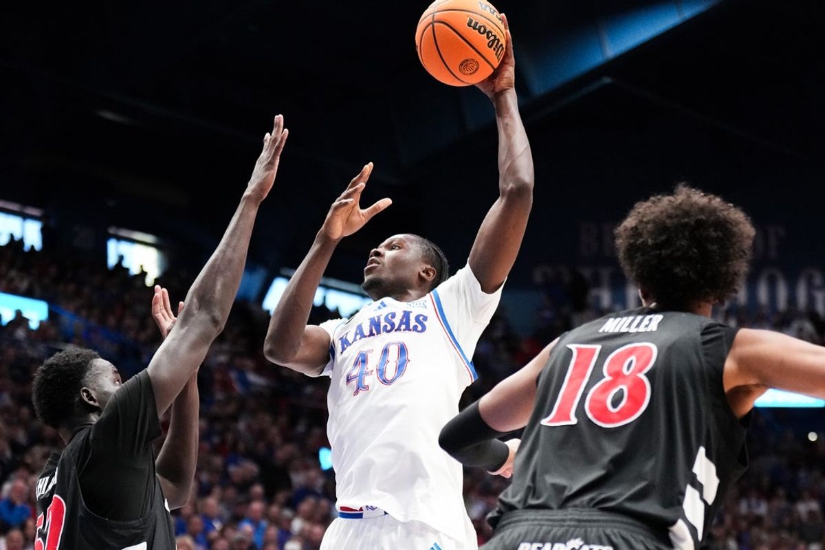 Feb 21, 2026; Lawrence, Kansas, USA; Kansas Jayhawks forward Flory Bidunga (40) shoots over Cincinnati Bearcats center Moustapha Thiam (52) during the first half of the game at Allen Fieldhouse. Mandatory Credit: Denny Medley-Imagn Images