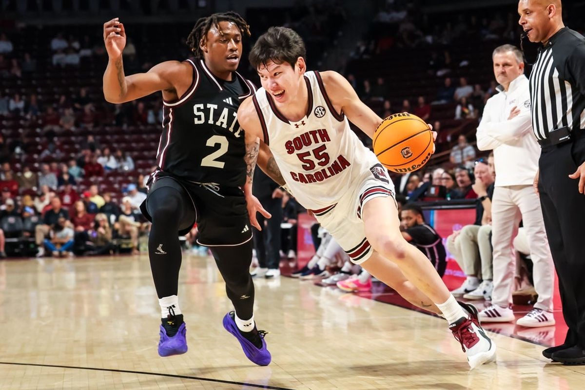 Feb 21, 2026; Columbia, South Carolina, USA; South Carolina Gamecocks guard Mike Sharavjamts (55) drives around Mississippi State Bulldogs guard Ja'borri McGhee (2) in the first half at Colonial Life Arena. Mandatory Credit: Jeff Blake-Imagn Images