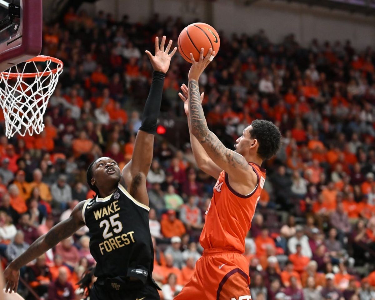 Feb 21, 2026; Blacksburg, Virginia, USA;  Virginia Tech Hokies guard Jailen Bedford (0) shoots a shot defended by Wake Forest Demon Deacons forward Tre'von Spillers (25) during the second half at Cassell Coliseum. Mandatory Credit: Brian Bishop-Imagn Images