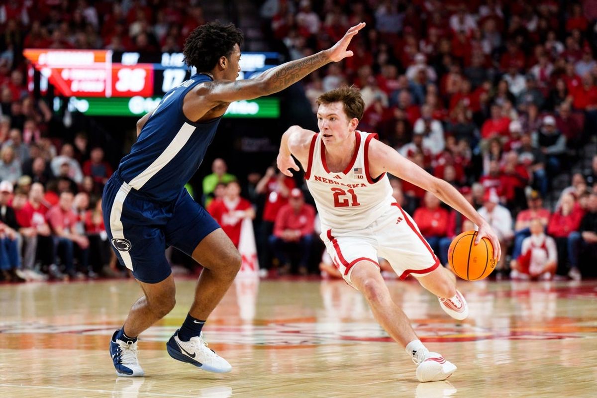 Feb 21, 2026; Lincoln, Nebraska, USA; Nebraska Cornhuskers forward Pryce Sandfort (21) drives against Penn State Nittany Lions forward Mason Blackwood (1) during the first half at Pinnacle Bank Arena. Mandatory Credit: Dylan Widger-Imagn Images