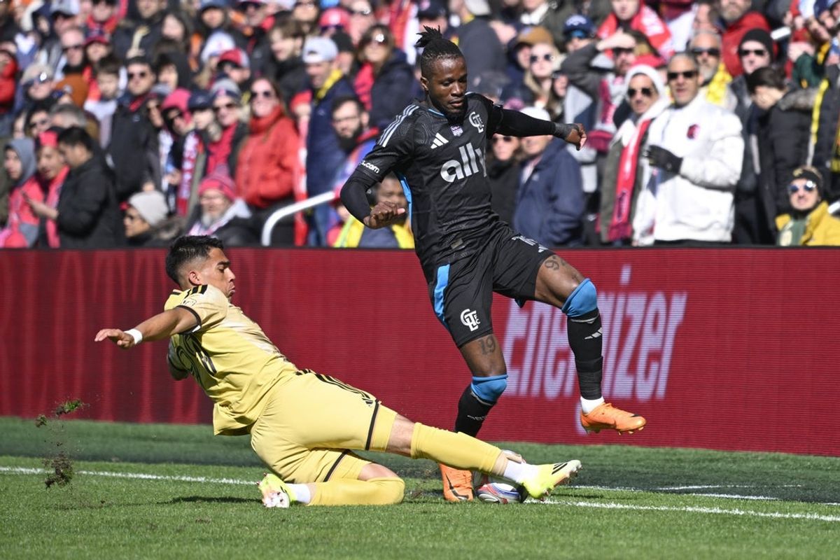 Feb 21, 2026; St. Louis, Missouri, USA; St. Louis CITY SC defender Jaziel Orozco (99) slide tackles Charlotte FC forward Wilfried Zaha (10) in the first half at Energizer Park. Mandatory Credit: Joe Puetz-Imagn Images
