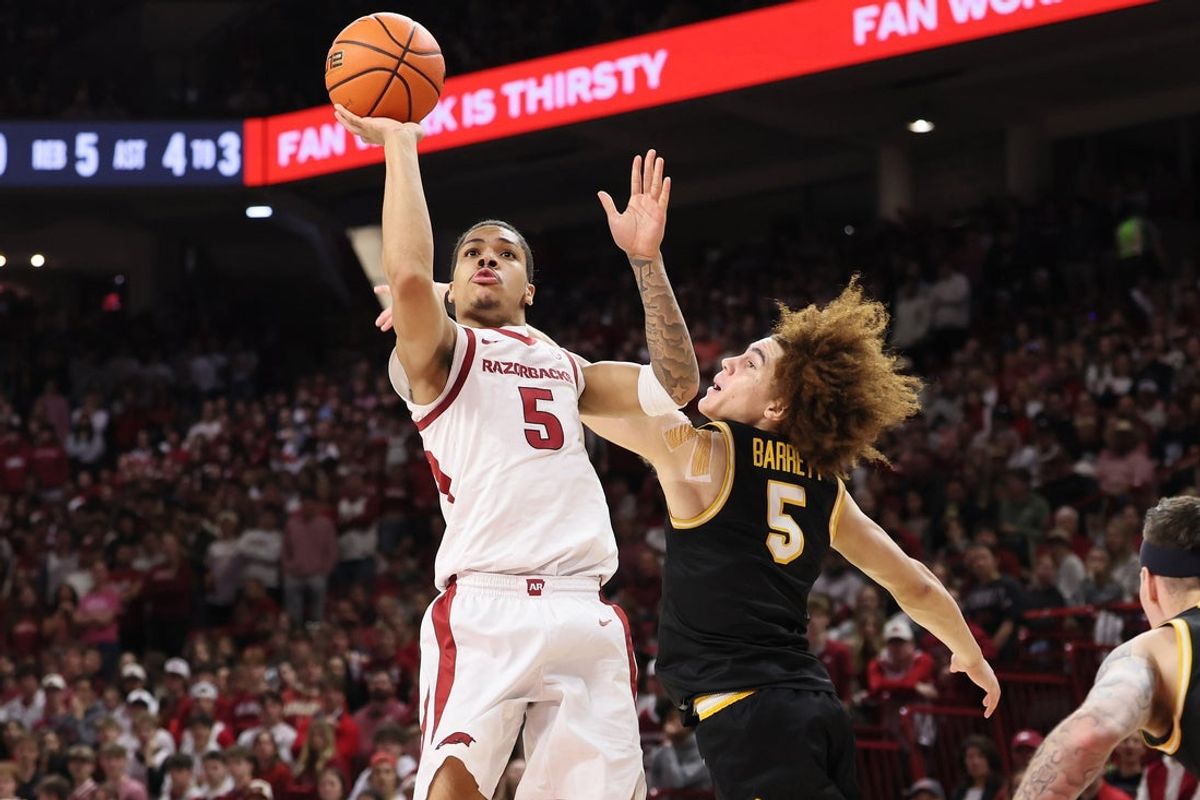 Feb 21, 2026; Fayetteville, Arkansas, USA; Arkansas Razorbacks guard Darius Acuff Jr (5) shoots during the first half as Missouri Tigers guard T.O. Barrett (5) defends at Bud Walton Arena. Mandatory Credit: Nelson Chenault-Imagn Images