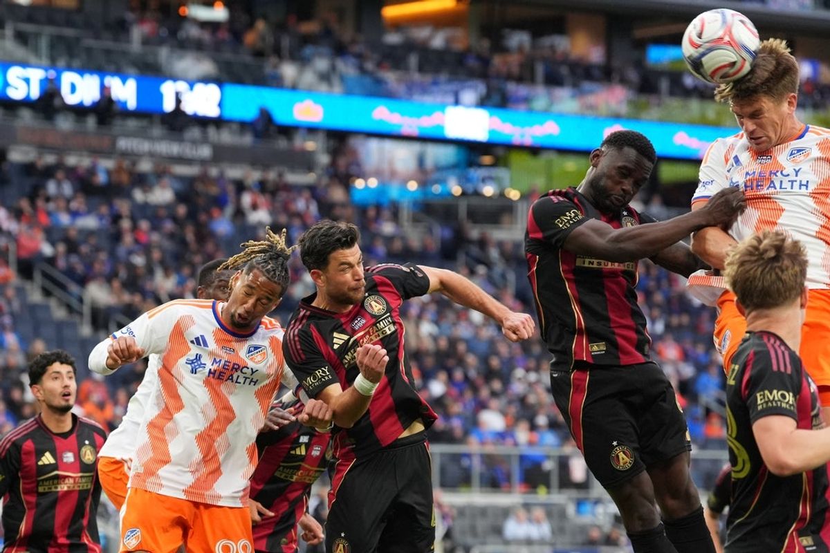 Feb 21, 2026; Cincinnati, Ohio, USA; FC Cincinnati defender Nick Hagglund (4) (right) heads the ball on goal during the first half against Atlanta United FC at TQL Stadium. Mandatory Credit: Kareem Elgazzar-Imagn Images