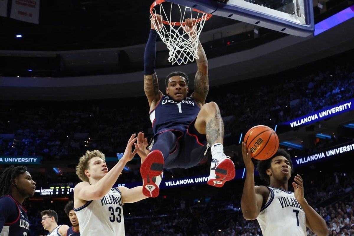 Feb 21, 2026; Philadelphia, Pennsylvania, USA; UConn Huskies guard Solo Ball (1) dunks the ball against the Villanova Wildcats during the first half at Xfinity Mobile Arena. Mandatory Credit: Bill Streicher-Imagn Images