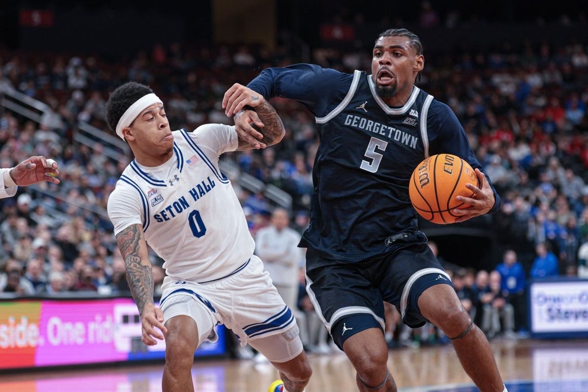 Feb 21, 2026; Newark, New Jersey, USA; Georgetown Hoyas guard KJ Lewis (5) drives to the basket against Seton Hall Pirates guard Adam Clark (0) during the first half at Prudential Center. Mandatory Credit: Vincent Carchietta-Imagn Images
