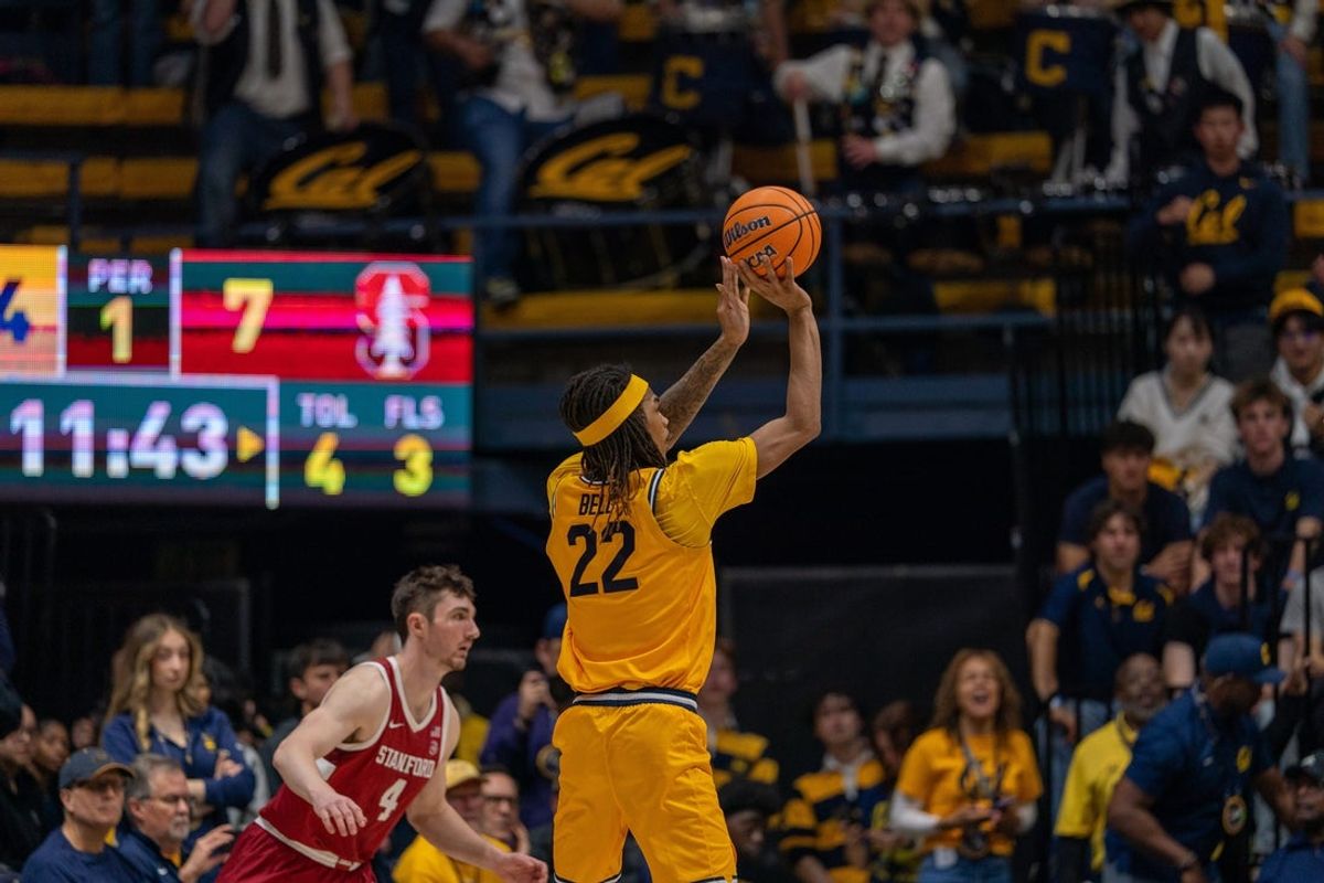 Feb 21, 2026; Berkeley, California, USA;  California Golden Bears forward Chris Bell (22) shoots a three point basket against Stanford Cardinal forward AJ Rohosy (4) during the first half at Haas Pavilion. Mandatory Credit: Neville E. Guard-Imagn Images