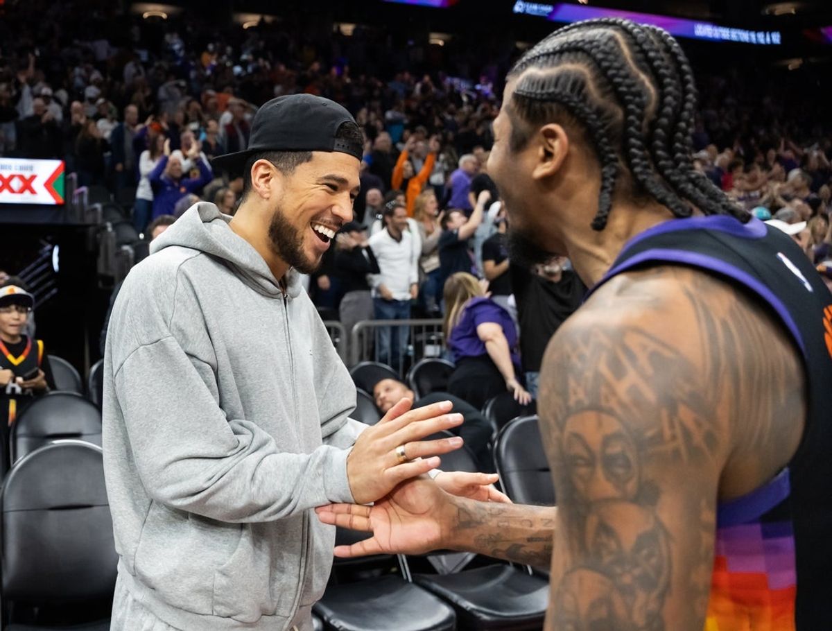 Feb 21, 2026; Phoenix, Arizona, USA; Phoenix Suns guard Devin Booker (left) celebrates with Jalen Green after defeating the Orlando Magic in double overtime at Mortgage Matchup Center. Mandatory Credit: Mark J. Rebilas-Imagn Images
