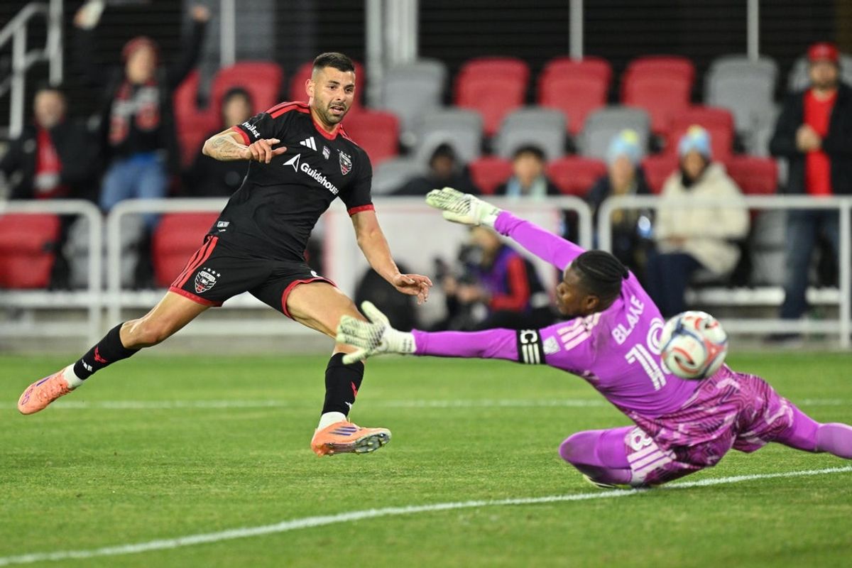 Feb 21, 2026; Washington, District of Columbia, USA;  DC United forward Tai Baribo (9) scores on Philadelphia Union goalkeeper Andre Blake (18) in the first half at Audi Field. Mandatory Credit: Jamie Sabau-Imagn Images