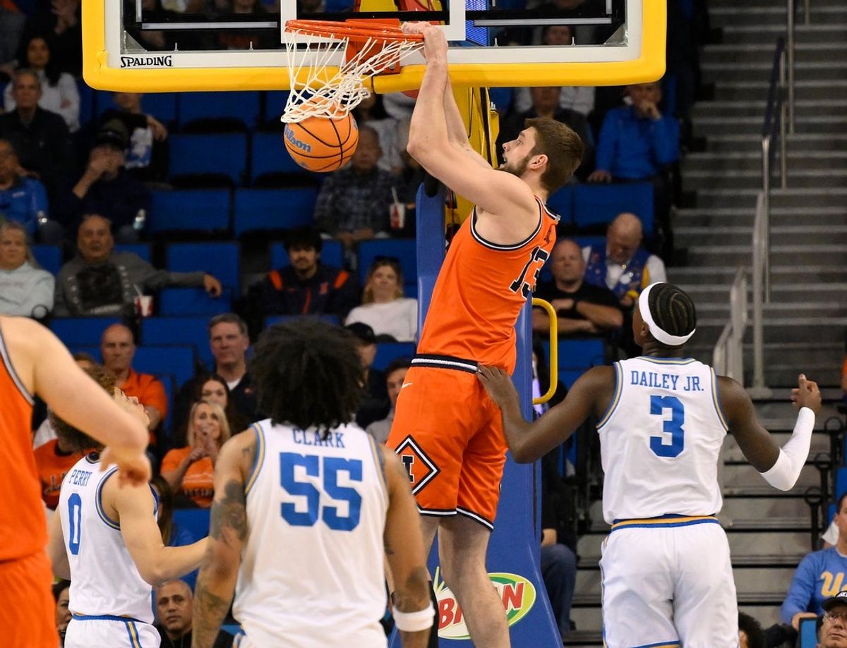 Feb 21, 2026; Los Angeles, California, USA; Illinois center Tomislav Ivisic (13) dunks the ball over UCLA player Trent Perry (0), Skyy Clark (55) and Eric Dailey Jr. (3) during the first half at Pauley Pavilion presented by Wescom Financial. Mandatory Credit: Robert Hanashiro-Imagn Images
