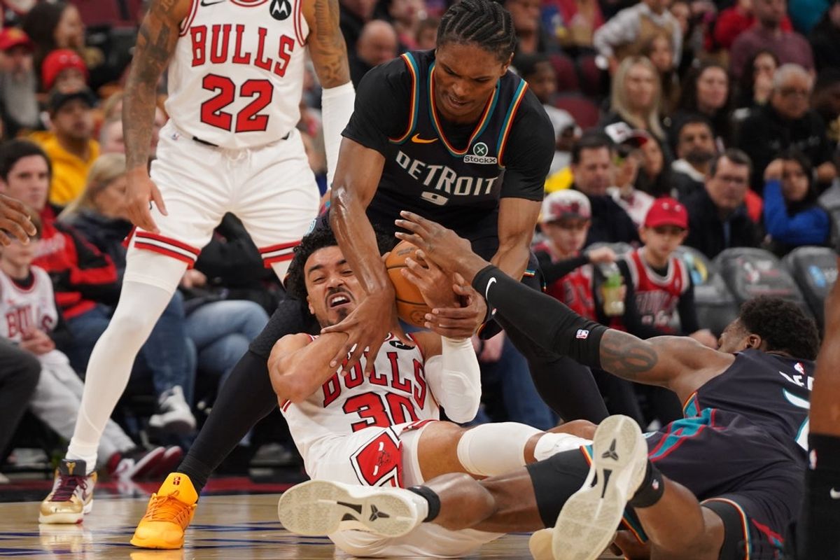 Feb 21, 2026; Chicago, Illinois, USA; Chicago Bulls guard Tre Jones (30) and Detroit Pistons guard Ausar Thompson (9) go for the ball during the first half at United Center. Mandatory Credit: David Banks-Imagn Images