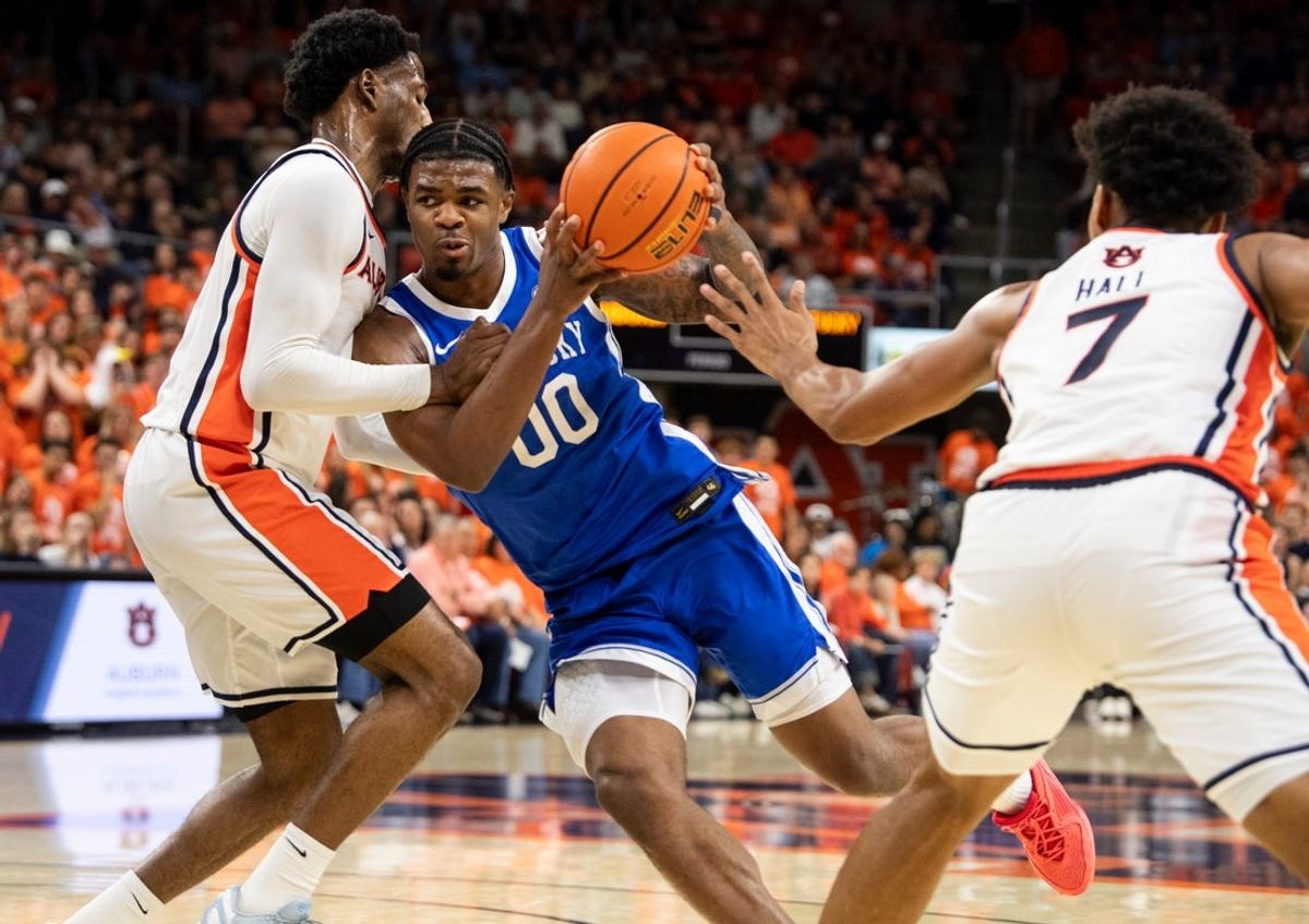 Kentucky Wildcats guard Otega Oweh (00) drives the ball on Auburn Tigers guard Kevin Overton (1) as Auburn Tigers take on Kentucky Wildcats at Neville Arena in Auburn, Ala. on Saturday, Feb. 21, 2026.