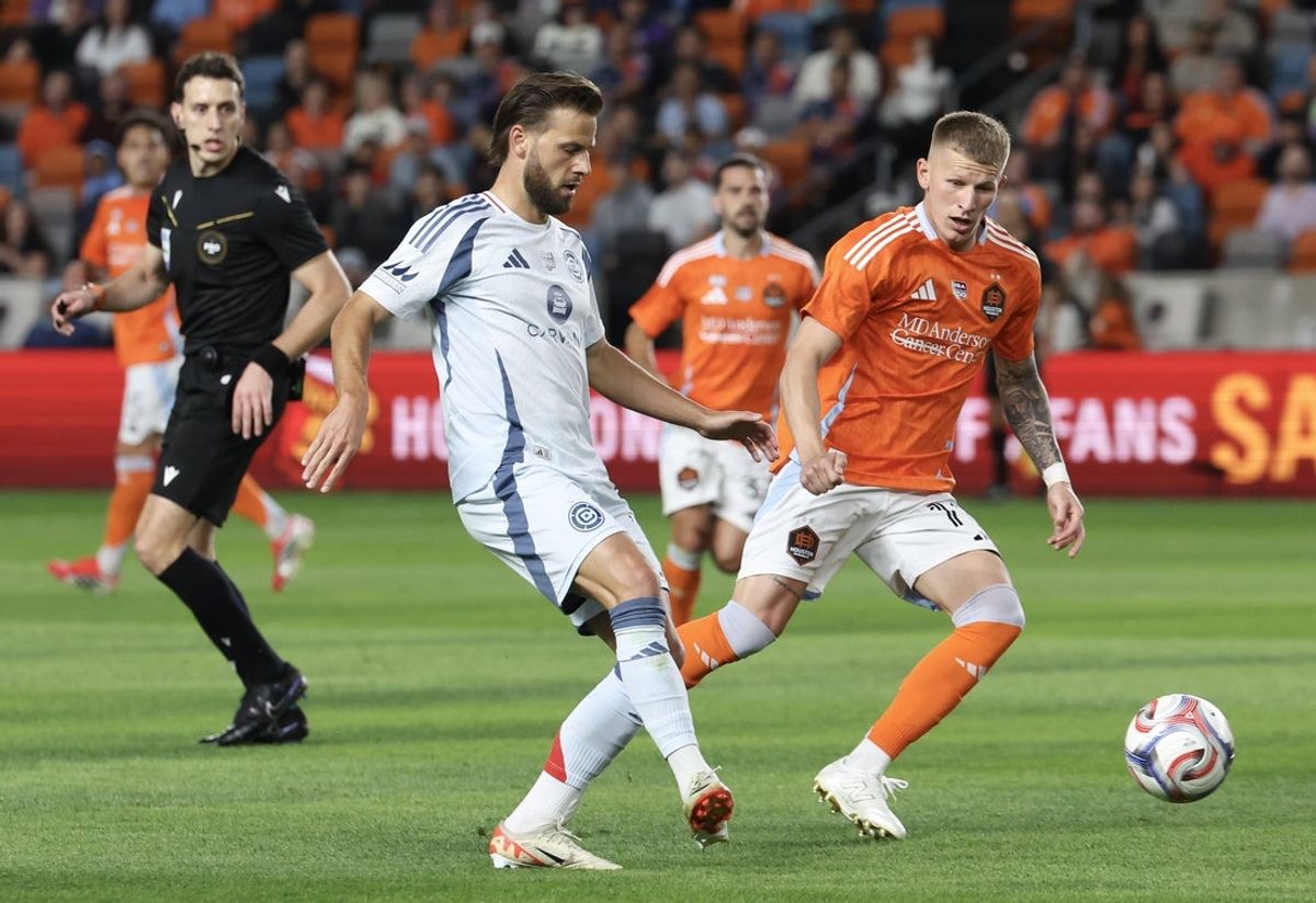 Feb 21, 2026; Houston, Texas, USA; Chicago Fire FC forward Hugo Cuypers (9) passes against Houston Dynamo FC forward Lawrence Ennali (11) in the first half at Shell Energy Stadium. Mandatory Credit: Thomas Shea-Imagn Images