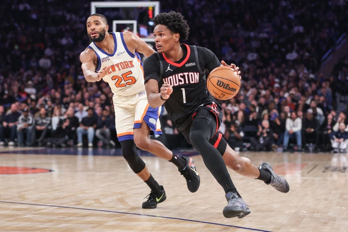 Feb 21, 2026; New York, New York, USA;  Houston Rockets guard Amen Thompson (1) drives past New York Knicks guard Mikal Bridges (25) in the second quarter at Madison Square Garden. Mandatory Credit: Wendell Cruz-Imagn Images
