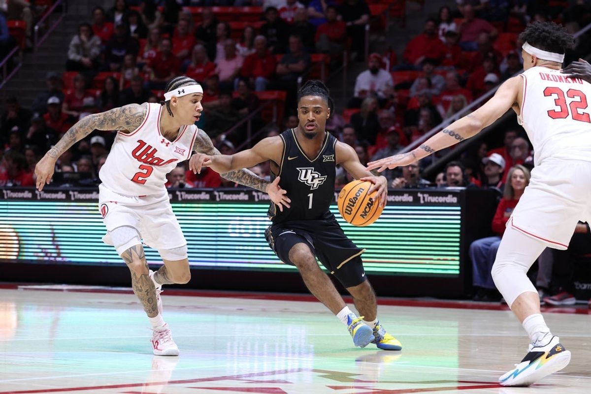 Feb 21, 2026; Salt Lake City, Utah, USA; UCF Knights guard Themus Fulks (1) advances the ball against Utah Utes guard Terrence Brown (2) during the first half at Jon M. Huntsman Center. Mandatory Credit: Rob Gray-Imagn Images