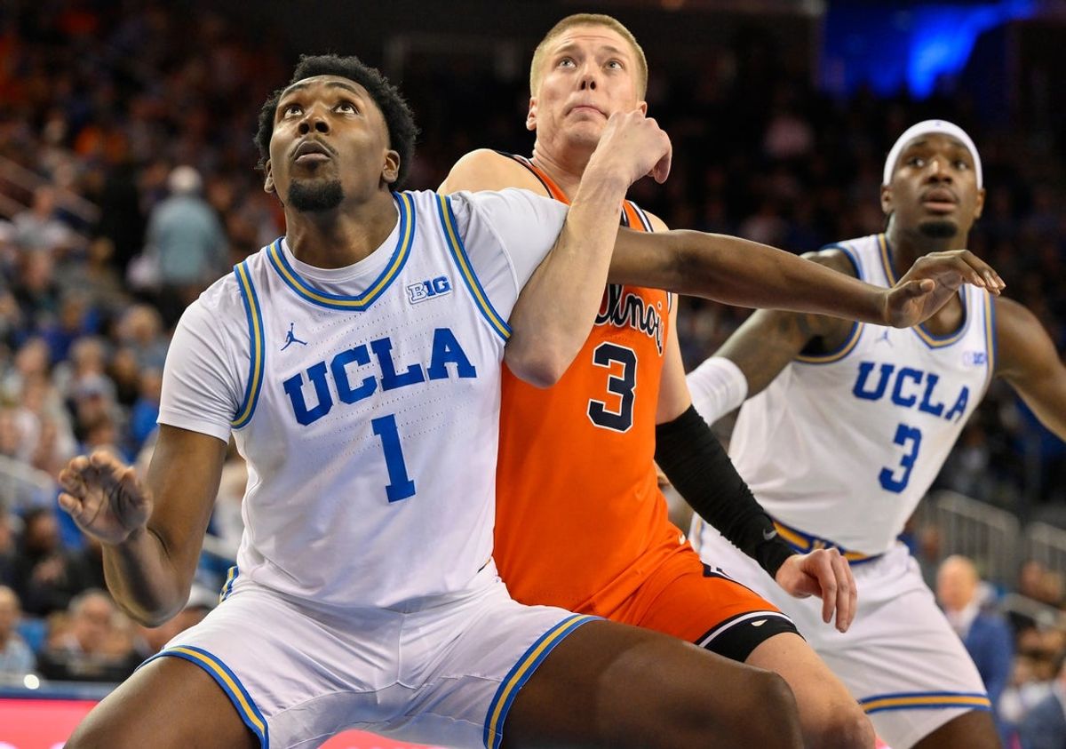 Feb 21, 2026; Los Angeles, California, USA; UCLA forward Xavier Booker (1) tangles up with Illinois forward Ben Humrichous (3) under the basket during the second half at Pauley Pavilion presented by Wescom Financial. Mandatory Credit: Robert Hanashiro-Imagn Images