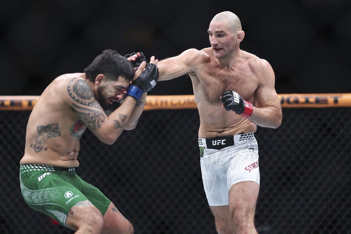 Feb 21, 2026; Houston, Texas, USA; Sean Strickland (red gloves) fights Anthony Hernandez (blue gloves) in a middleweight bout during UFC Fight Night at Toyota Center. Mandatory Credit: Troy Taormina-Imagn Images