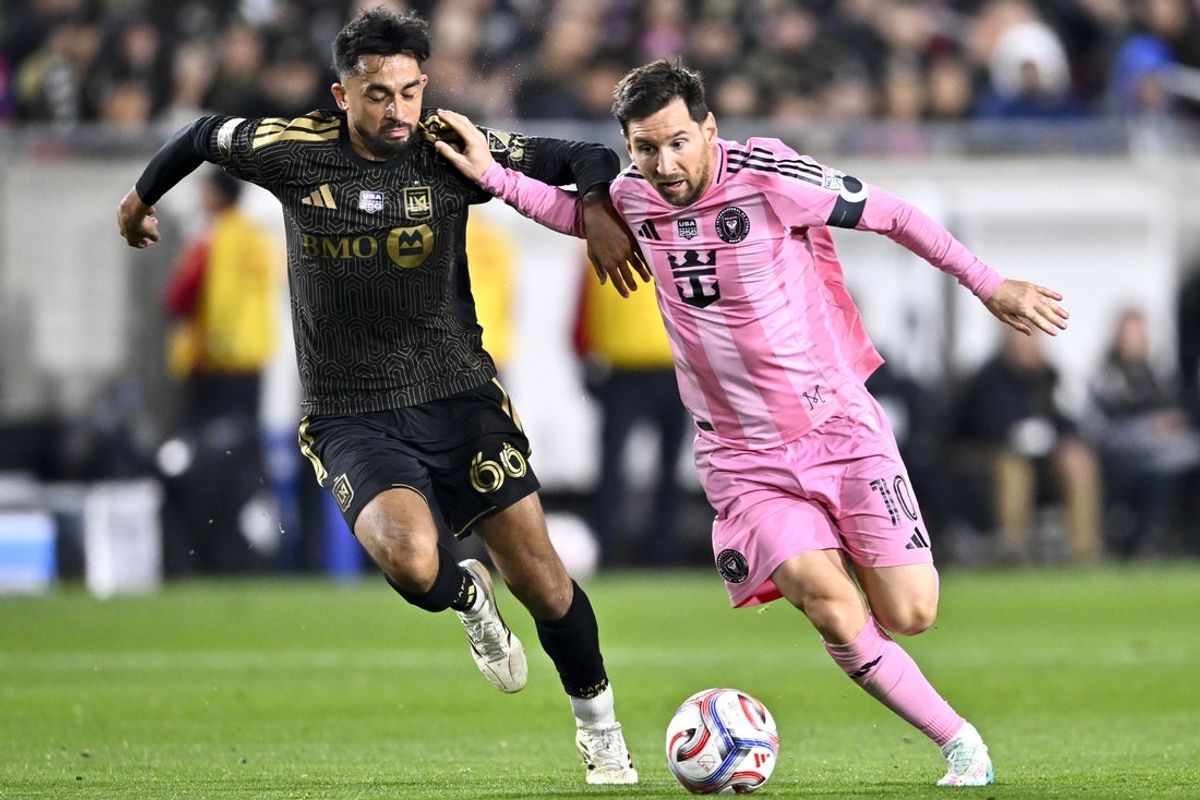 Feb 21, 2026; Los Angeles, California, USA; Inter Miami CF forward Lionel Messi (10) moves the ball against Los Angeles FC midfielder Mathieu Choinière (66) during the second half at Los Angeles Memorial Coliseum. Mandatory Credit: Kelvin Kuo-Imagn Images