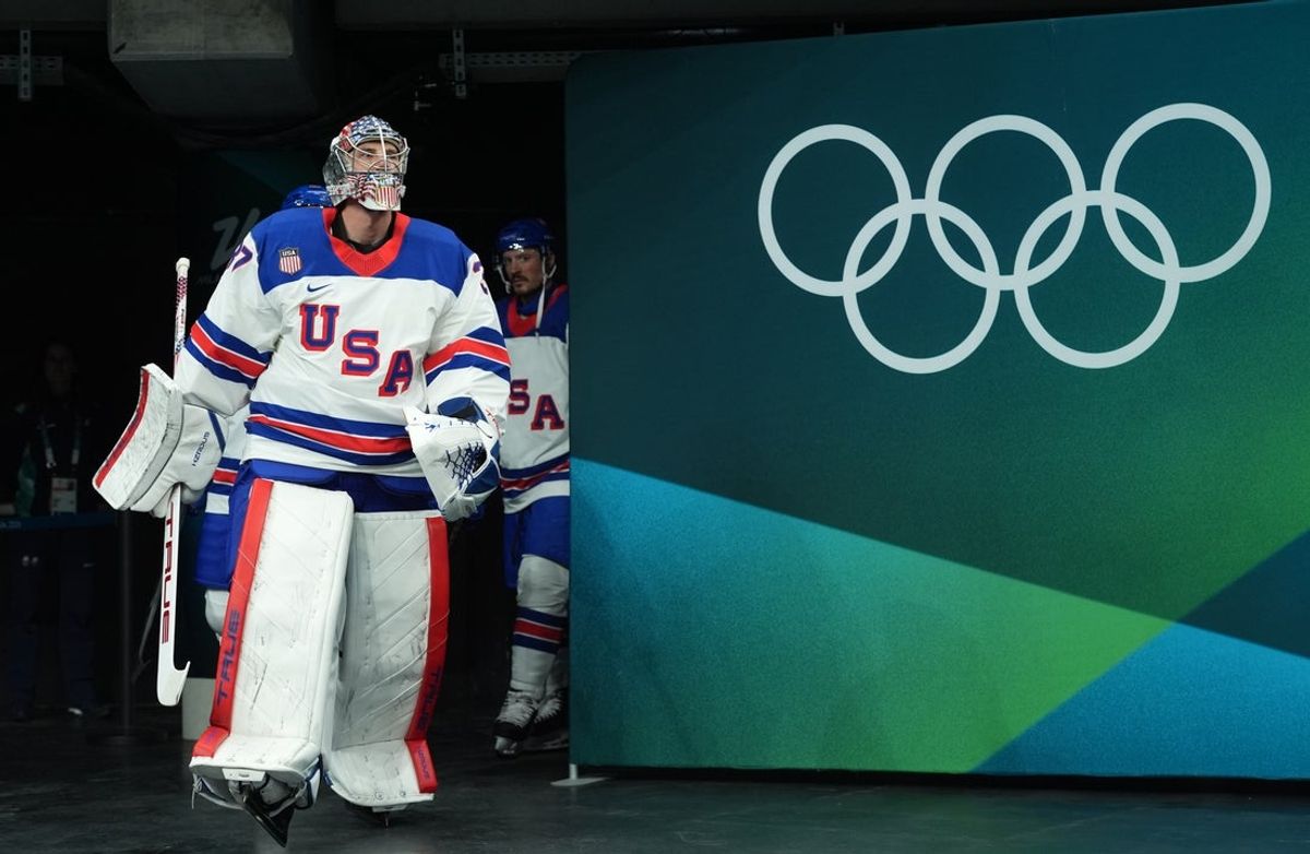 Feb 22, 2026; Milan, Italy;  Connor Hellebuyck (37) of the United States leads the team to the ice before playing against Canada in the men's ice hockey gold medal game during the Milano Cortina 2026 Olympic Winter Games at Milano Santagiulia Ice Hockey Arena. Mandatory Credit: Amber Searls-Imagn Images