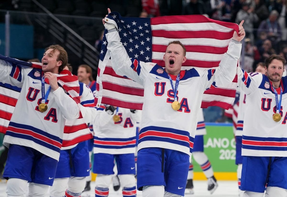 Feb 22, 2026; Milan, Italy;  United States players including Brady Tkachuk (7) of the United States celebrate after defeating Canada in the men's ice hockey gold medal game during the Milano Cortina 2026 Olympic Winter Games at Milano Santagiulia Ice Hockey Arena. Mandatory Credit: Amber Searls-Imagn Images
