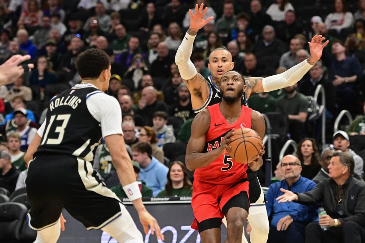 Feb 22, 2026; Milwaukee, Wisconsin, USA;  Toronto Raptors guard Immanuel Quickley (5) looks for a shot against Milwaukee Bucks guard Ryan Rollins (13) in the first quarter at Fiserv Forum. Mandatory Credit: Benny Sieu-Imagn Images
