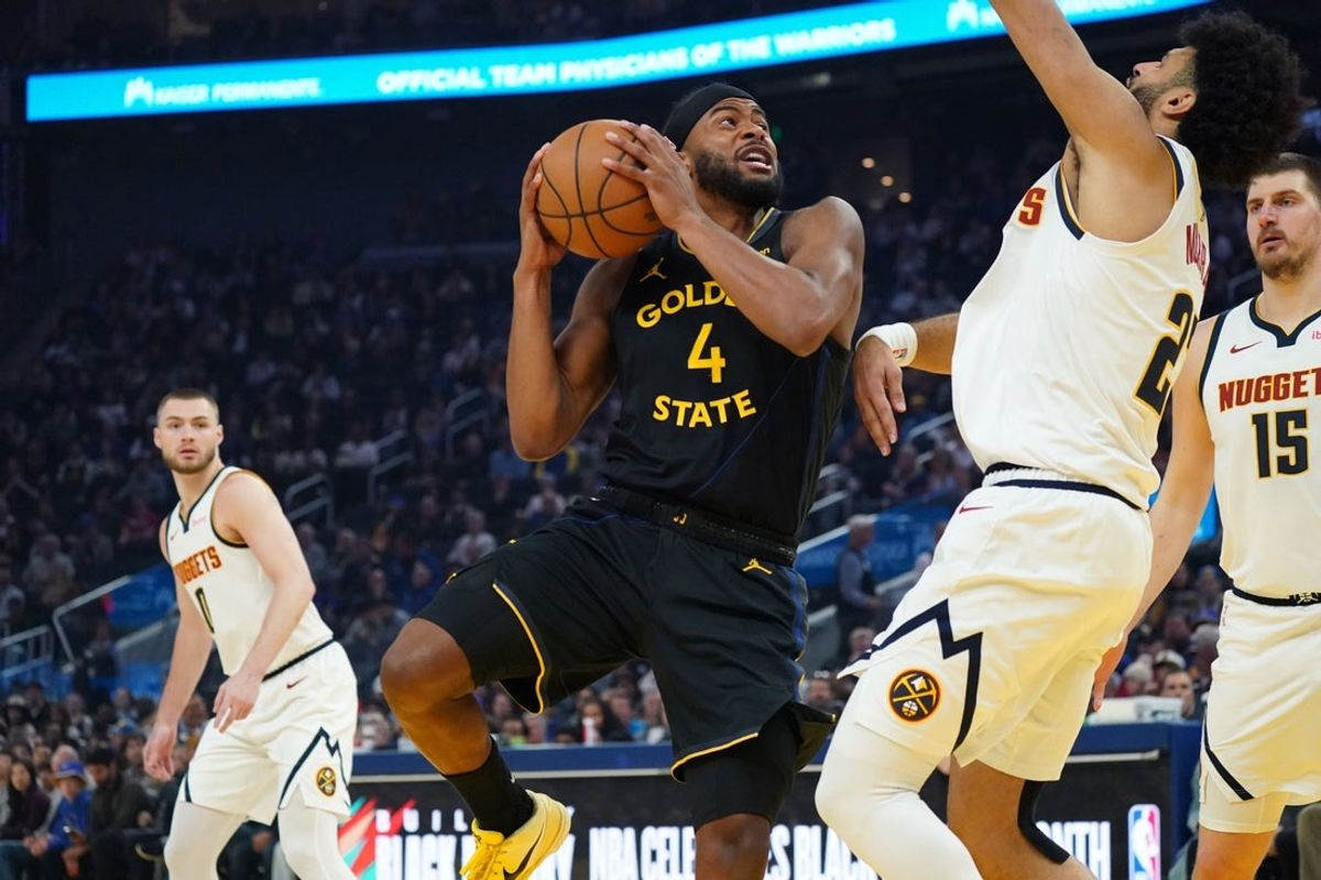 Feb 22, 2026; San Francisco, California, USA;  Golden State Warriors guard Moses Moody (4) shoots against Denver Nuggets guard Jamal Murray (27) as guard Christian Braun (0) and center Nikola Jokic (15) look on in the first quarter at Chase Center. Mandatory Credit: David Gonzales-Imagn Images