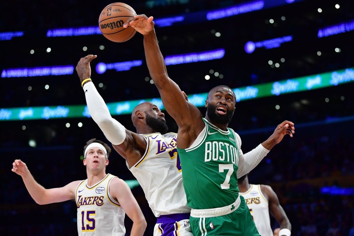 Feb 22, 2026; Los Angeles, California, USA; Boston Celtics guard Jaylen Brown (7) plays for the rebound against Los Angeles Lakers forward LeBron James (23) during the first half at Crypto.com Arena. Mandatory Credit: Gary A. Vasquez-Imagn Images
