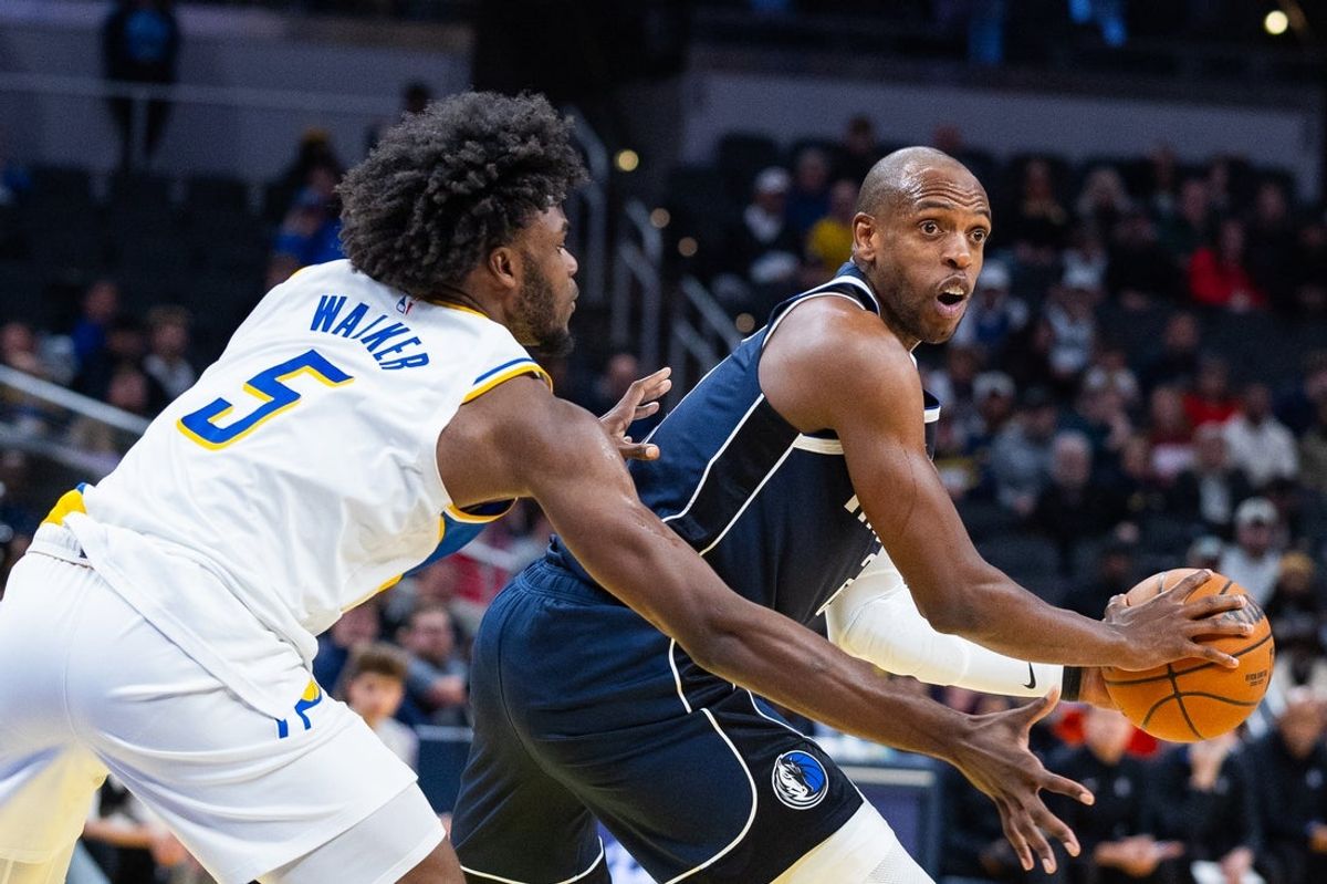 Feb 22, 2026; Indianapolis, Indiana, USA;  Dallas Mavericks forward Khris Middleton (20) holds the ball while  Indiana Pacers forward Jarace Walker (5) defends in the second half at Gainbridge Fieldhouse. Mandatory Credit: Trevor Ruszkowski-Imagn Images