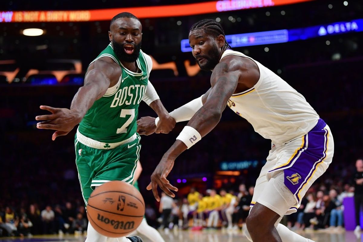 Feb 22, 2026; Los Angeles, California, USA; Boston Celtics guard Jaylen Brown (7) and Los Angeles Lakers center Deandre Ayton (5) play for the ball during the second half at Crypto.com Arena. Mandatory Credit: Gary A. Vasquez-Imagn Images