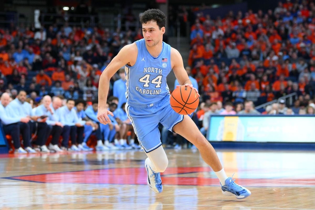 Feb 21, 2026; Syracuse, New York, USA; North Carolina Tar Heels guard Luka Bogavac (44) drives during the first half against the Syracuse Orange at the JMA Wireless Dome. Mandatory Credit: Rich Barnes-Imagn Images