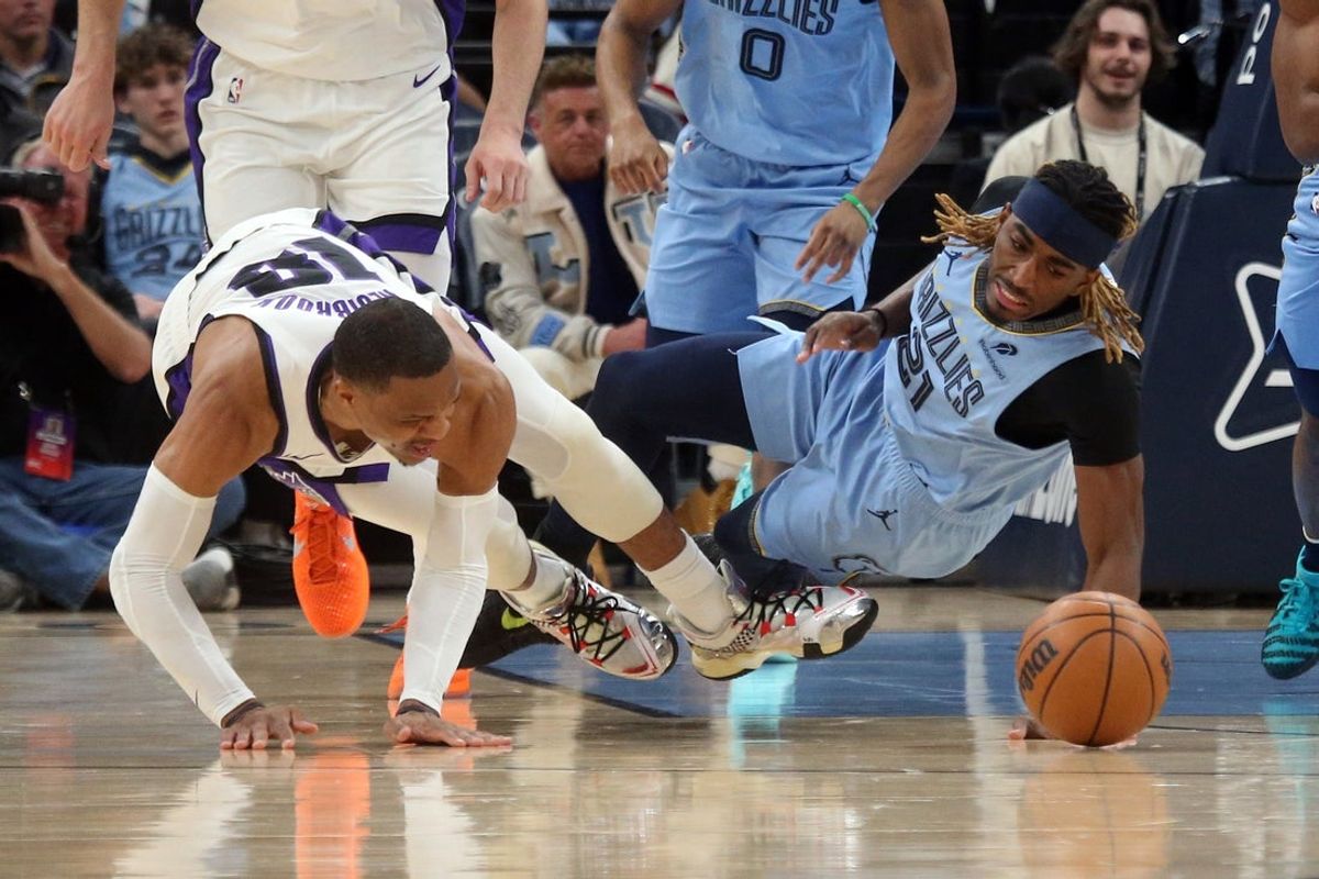 Feb 23, 2026; Memphis, Tennessee, USA; Sacramento Kings guard Russell Westbrook (18) and Memphis Grizzlies guard Jahmai Mashack (21) battle for a loose ball during the first quarter at FedExForum. Mandatory Credit: Petre Thomas-Imagn Images