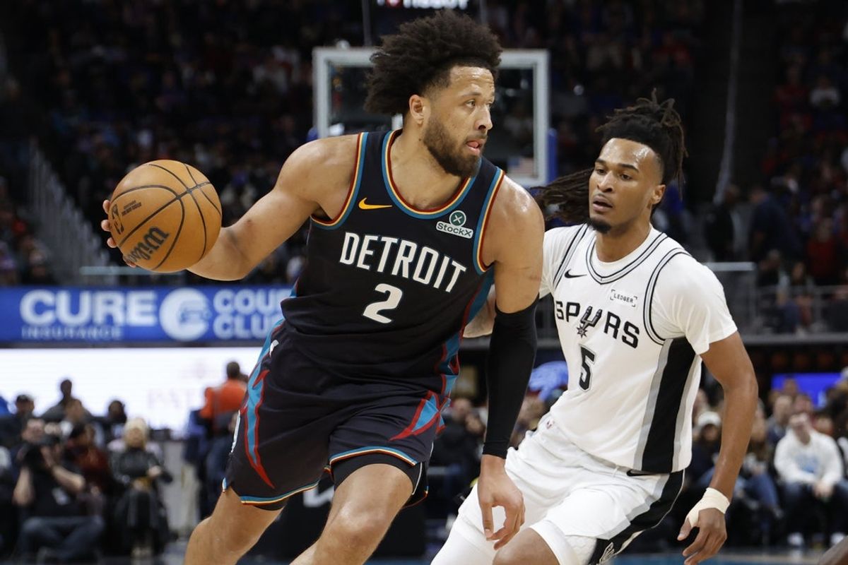 Feb 23, 2026; Detroit, Michigan, USA;  Detroit Pistons guard Cade Cunningham (2) dribbles on San Antonio Spurs guard Stephon Castle (5) in the second half at Little Caesars Arena. Mandatory Credit: Rick Osentoski-Imagn Images